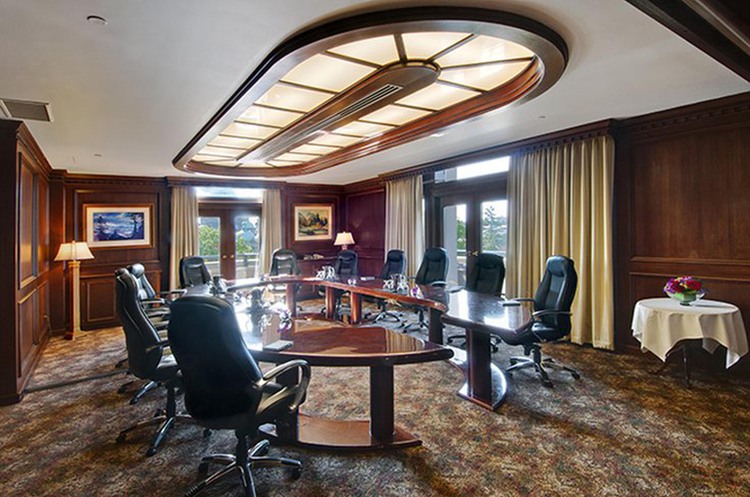 U-shaped meeting room with black plush chairs