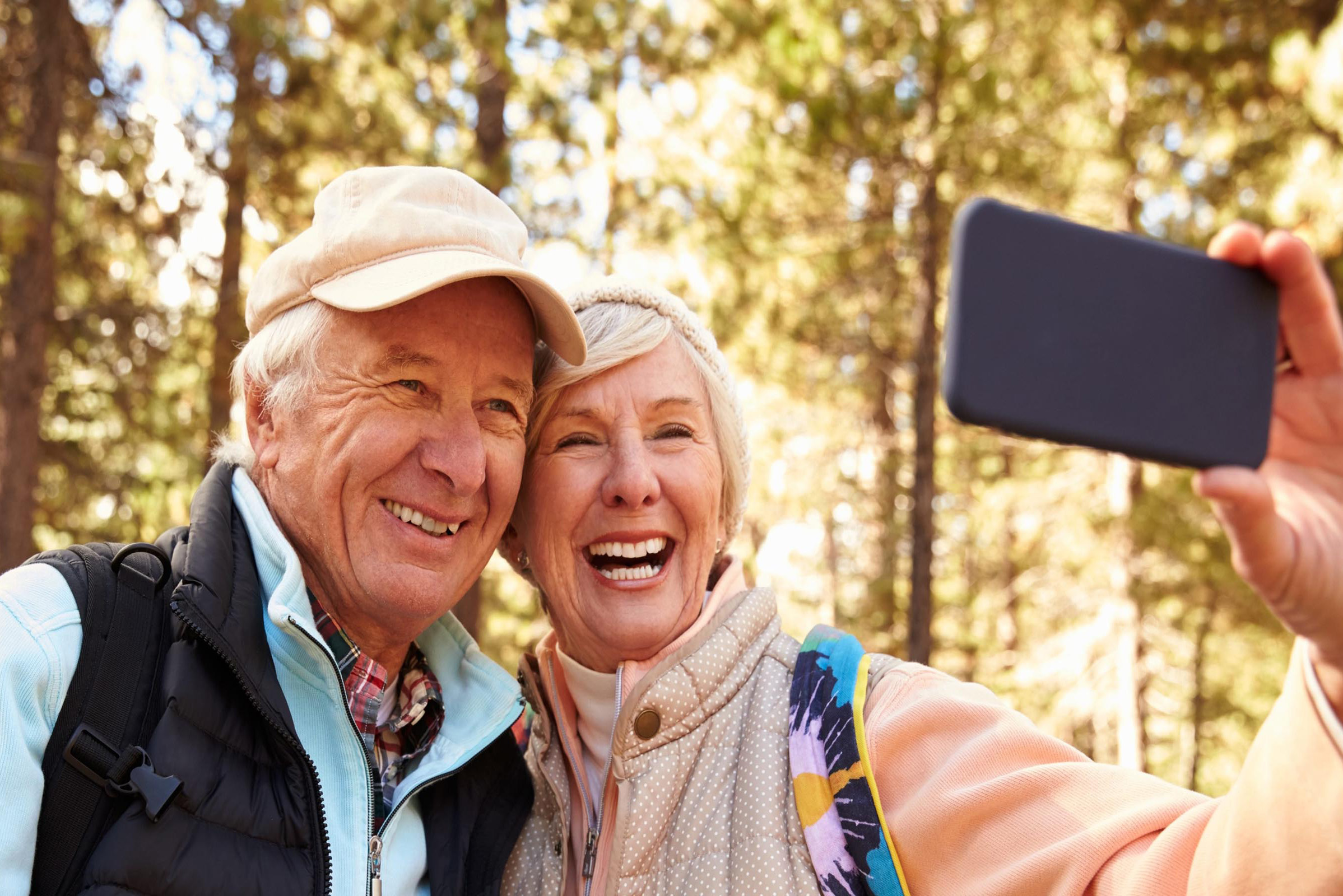 elderly couple taking a selfie in nature
